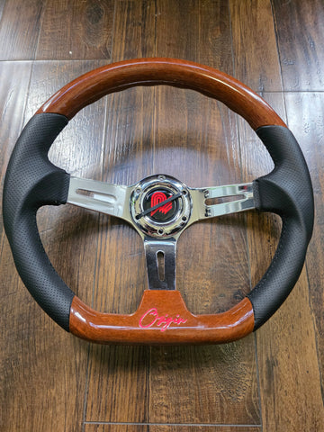 Wooden steering wheel with black rim on a wooden surface